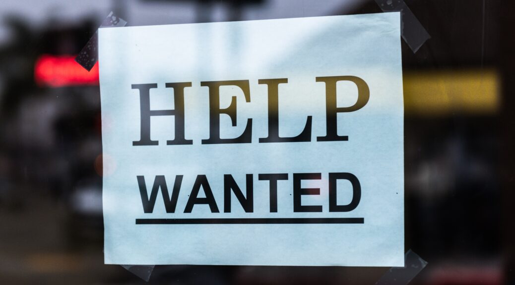Sign that states "Help Wanted"